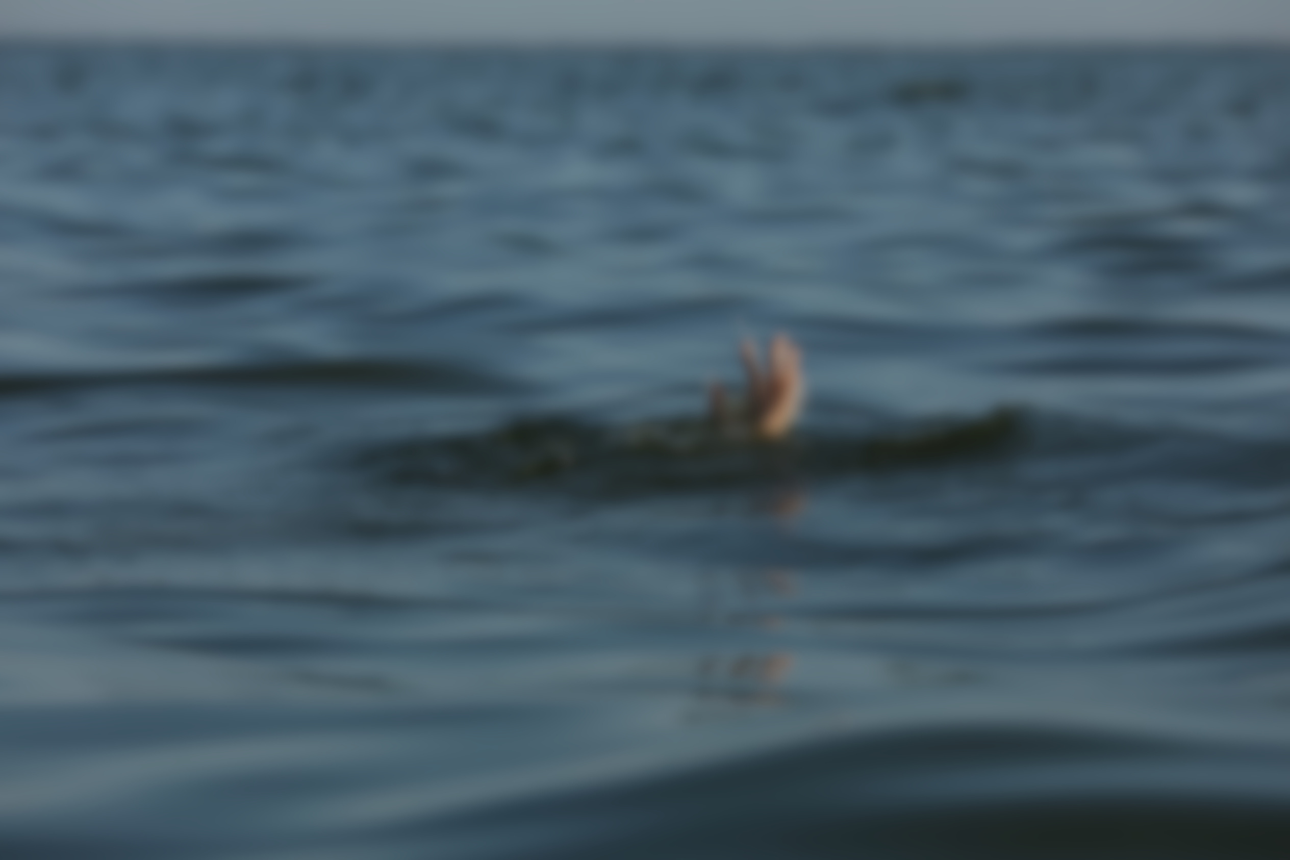Drowning Woman Reaching for Help in Sea