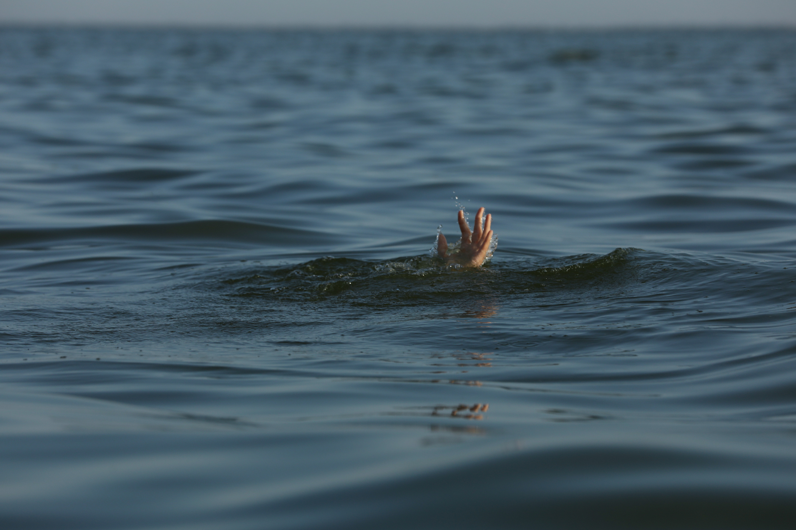 Drowning Woman Reaching for Help in Sea